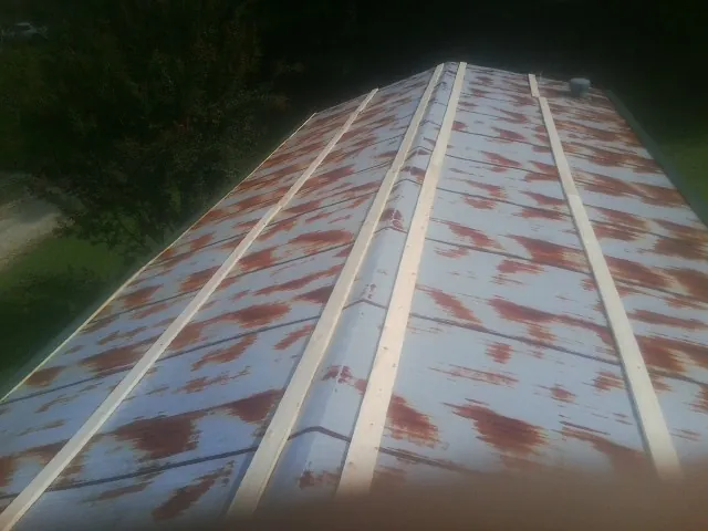 Rusted metal roof panels with new wood purlins before replacement — Storm Damage Roof Repair in Tecate by Roofing Brothers