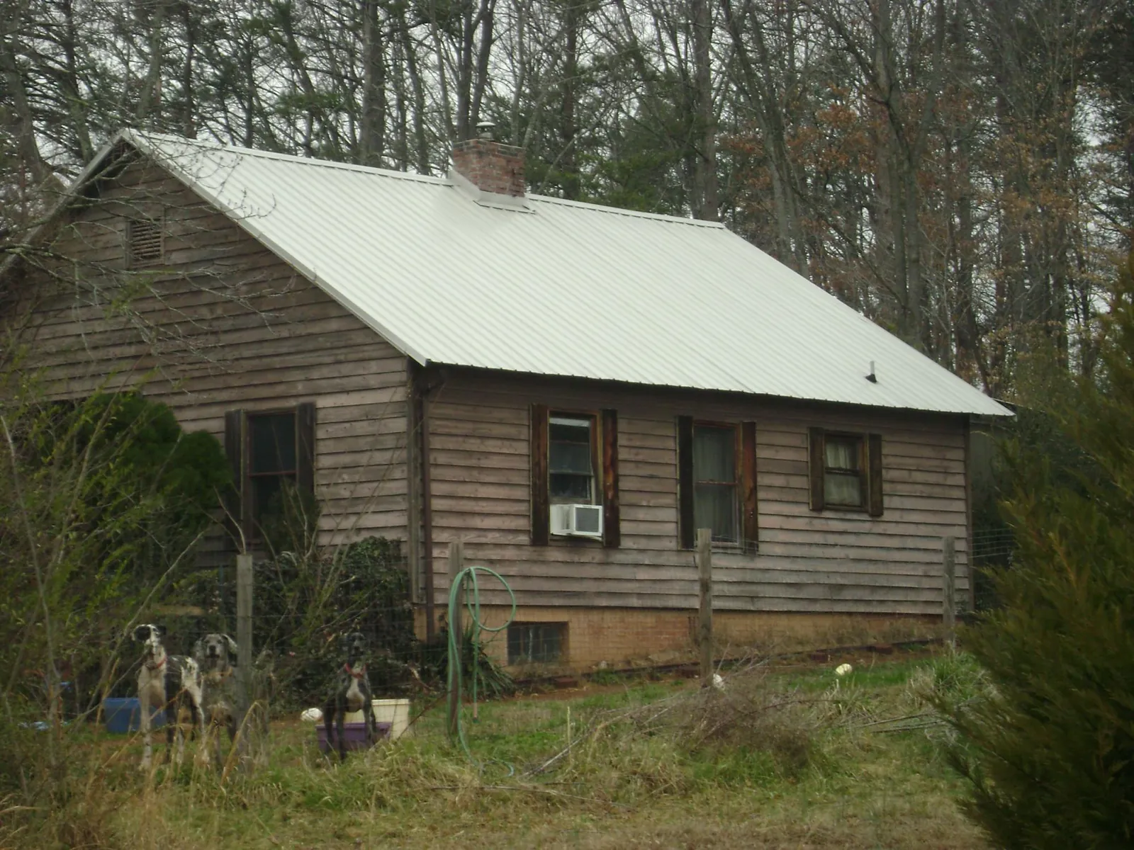 White metal roof on an old wood sided farmhouse, from a Metal Roof Installation job in Tecate